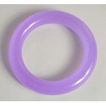 A LILAC JADE BANGLE. 3.25ins diameter.