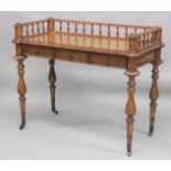 A 19TH CENTURY STYLE WALNUT WRITING TABLE with spindle back, sliding drawer with fall front