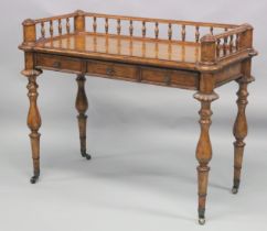 A 19TH CENTURY STYLE WALNUT WRITING TABLE with spindle back, sliding drawer with fall front