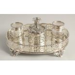 A SUPERB VICTORIAN SILVER OVAL INKSTAND with pierced gallery, two glass top bottles and silver