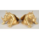 A PAIR OF GILT BRONZE RHINO DESK WEIGHTS. 5ins long.