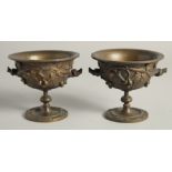 A SMALL PAIR OF GRAND TOUR BRONZE CIRCULAR URNS. 4.5ins diameter.