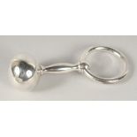 A BABY'S SILVER RATTLE in a white box.