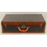 A LOUIS VUITTON SUITCASE. No. 819485, with Louis Vuitton label. From Arthur Gilbert, New York.