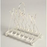 A SILVER PLATED SIX DIVISION TOAST RACK with cross golf clubs.