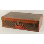 A LOUIS VUITTON SUITCASE. No. 771989 with Louis Vuitton label. FROM Saks & Co., New York. Lock no.