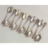 A SET OF TEN GEORGE II PICTURE BACK SILVER TEASPOONS with cast classical head finials.