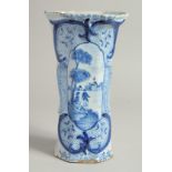 A DUTCH BLUE AND WHITE TIN GLAZE VASE with figures in a landscape. 9ins high.