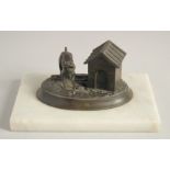 A BRONZED OVAL INKSTAND with a dog, on a marble base. 6.5ins