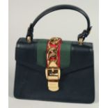 A GOOD GUCCI SMALL CLUTCH BAG 7.5ins x 5.5ins with gilt Gucci lock and leather handles.