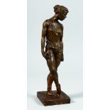 AFTER DEGAS A BRONZED STANDING FEMALE FIGURE on a square base. 13ins high.