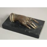 AN ITALIAN BRONZE HAND. 5ins long on a black marble base.