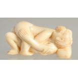 A CARVED BONE EROTIC NETSUKE. 2ins long.