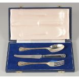 A MAPPIN & WEBB THREE PIECE CHRISTENING SET, spoon, knife & fork in a blue box.