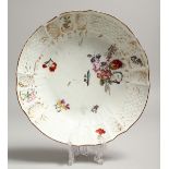 A MEISSEN PLATE painted with flowers. Cross swords mark in blue. 8ins diameter.