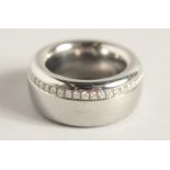 A DESIGNER TITANIUM RING set with diamonds. 27.8gms.