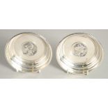 A SMALL PAIR OF SILVER PLATED CIRCULAR DISHES with cast handles. 4.25ins diameter.