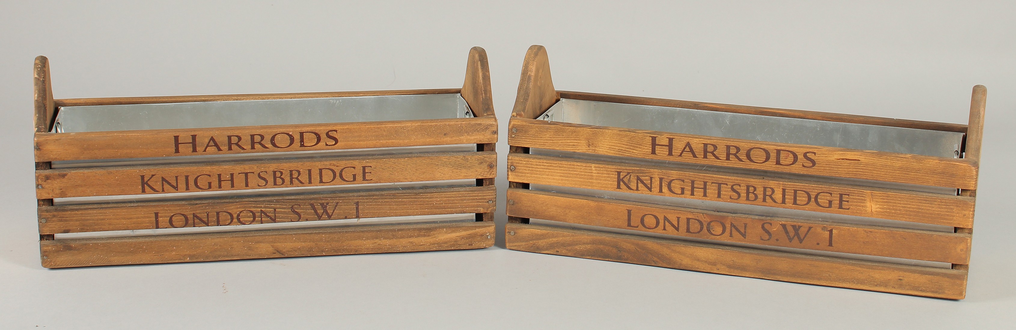 A SMALL PAIR OF "HARRODS" WOODEN BOXES. 1ft 2ins long with wooden liners.