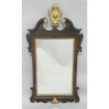 A GEORGE III MAHOGANY AND GILDED FRETWORK FRAMED WALL MIRROR, with swan neck pediment, curved and