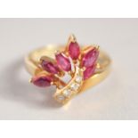 A GOLD DIAMOND AND RUBY FLOWER RING.