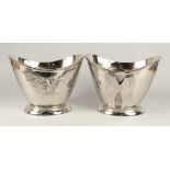 A PAIR OF OVAL CHAMPAGNE COOLERS WITH WINGS 1ft 2ins wide.