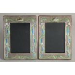 A PAIR OF SILVER AND ENAMEL PHOTOGRAPH FRAMES. 7.5ins X 5.5ins.