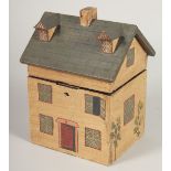 A WOODEN COTTAGE TEA CADDY. 8ins high.