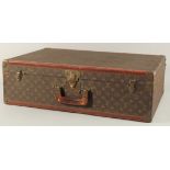 A LOUIS VUITTON SUITCASE. Louis Vuitton label missing. Lock no. H9. 27.5ins long x 18.5ins wide x