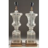 A GOOD PAIR OF GLASS URN SHAPED LAMPS AND BASES 2ft high.