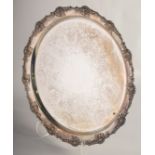 A CIRCULAR ENGRAVED SILVER PLATED TEA TRAY with cast fruiting vine edge. 15ins diameter.