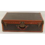 A LOUIS VUITTON SUITCASE. No. 82154 with Louis Vuitton label. Saks & Co., New York label. Pull-out