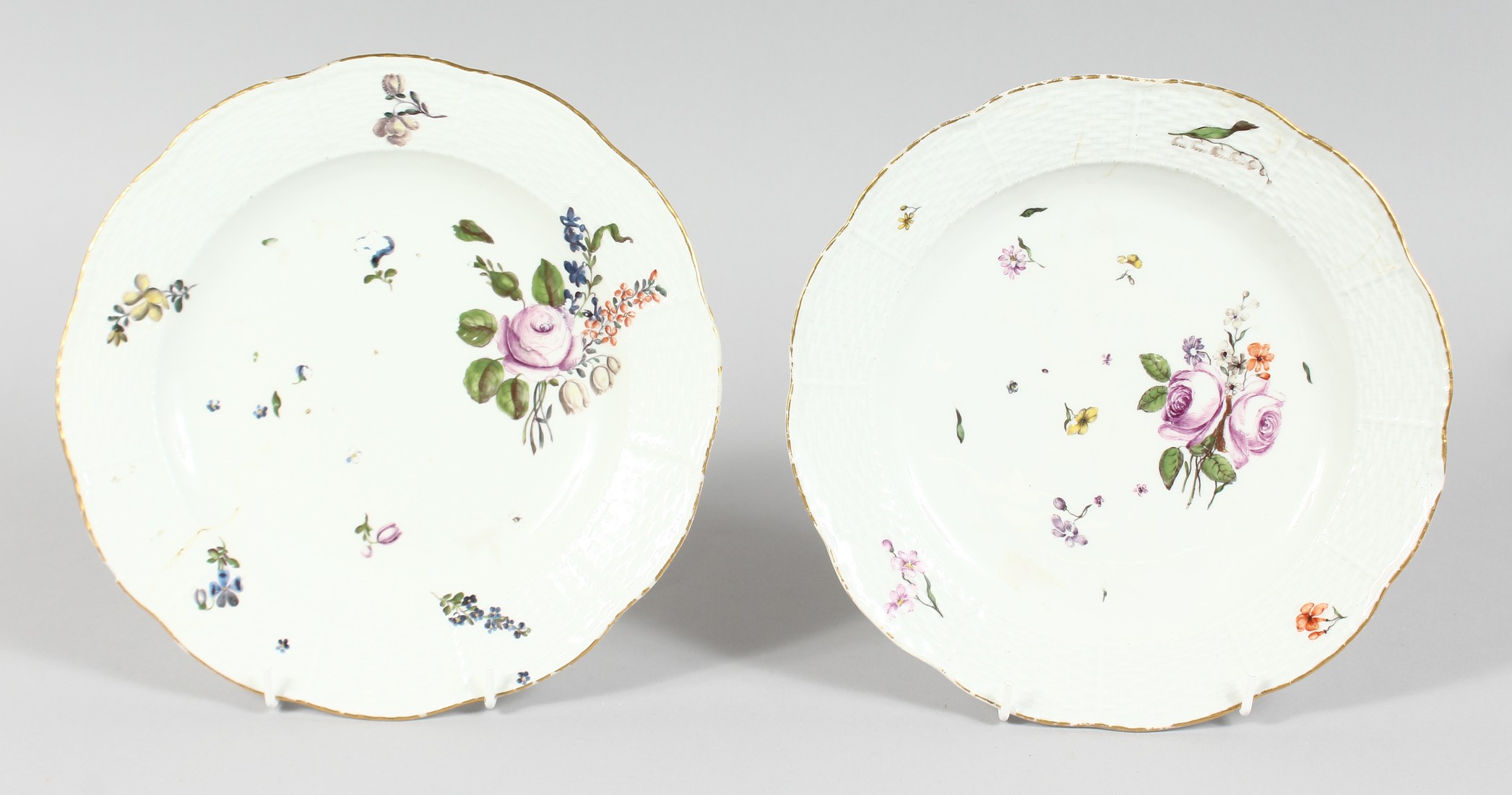 A GOOD PAIR OF MEISSEN CIRCULAR PLATES sprigged and painted with flowers. Cross swords mark in blue.