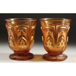 A PAIR OF AMBER TINTED BEYKOS BEAKERS. 4.75ins