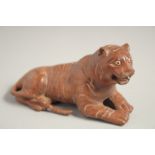 A CARVED WOOD TIGER. 5.5ins long.