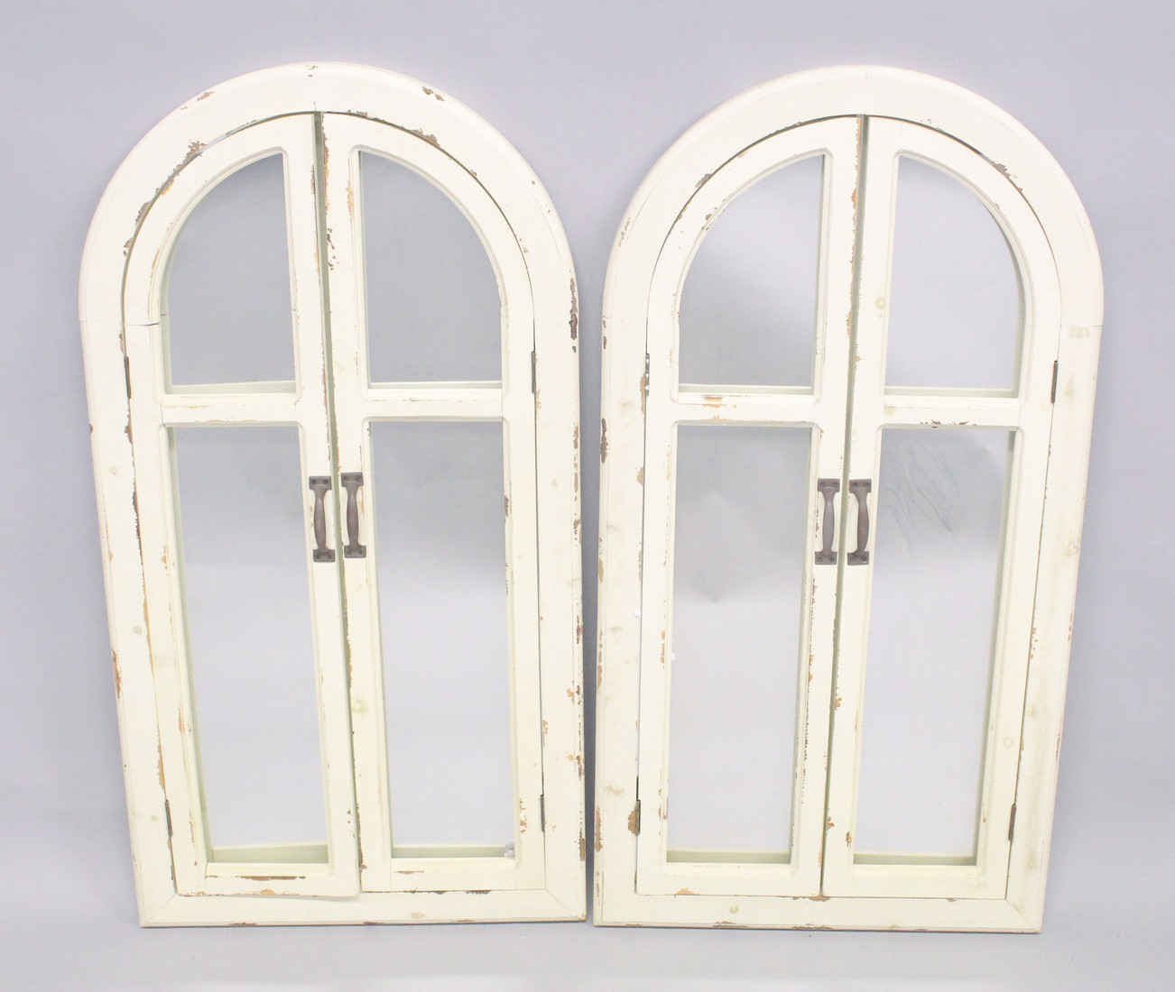 A PAIR OF WHITE ARCHED SHUTTER MIRRORS. 3ft 6ins x 1st 8ins.
