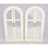 A PAIR OF WHITE ARCHED SHUTTER MIRRORS. 3ft 6ins x 1st 8ins.