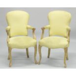 A PAIR OF FRENCH HEPPLEWHITE GILDED ARMCHAIRS with yellow padded backs and seats.