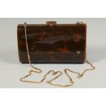 A FAUX TORTOISESHELL EVENING PURSE with long gilt chain. 7ins long.