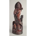 A CHINESE CARVED ROSEWOOD FIGURE. 1ft 11ins long.