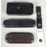 THREE LEATHER CIGAR CASES AND TWO CUTTERS (5).