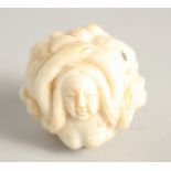 A CHINESE CARVED BALL NETSUKE "NUDE". 1.25ins diameter.