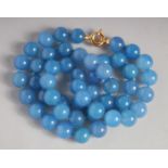 A BLUE BEAD NECKLACE with gold clasp. 24ins long.