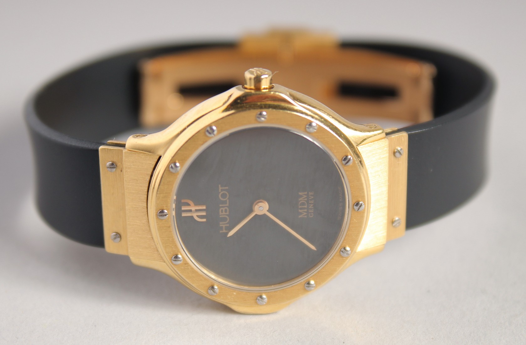 A LADIES 18CT GOLD HUBLOT WRISTWATCH with leather strap.