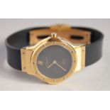 A LADIES 18CT GOLD HUBLOT WRISTWATCH with leather strap.