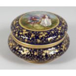 A GOOD 19TH CENTURY SHAPED PORCELAIN CIRCULAR BOX AND COVER, blue and gilt ground, the lid painted