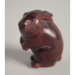 A WOODEN NETSUKE OF A RABBIT. 1.75ins.