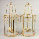 A VERY GOOD PAIR OF GILT CIRCULAR LANTERNS with glass panels. 2ft 8ins high x 1ft 3ins diameter.