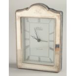 A SILVER UPRIGHT EASEL CLOCK by R. CARR, with bead edge. 6.5ins high x 4.5ins wide.