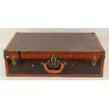 A LOUIS VUITTON SUITCASE. No. 81494, with Louis Vuitton label. Related label, bought from SAKS & Co.