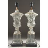 A GOOD PAIR OF GLASS URN SHAPED LAMPS AND BASES 2ft high.